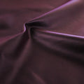A swirled sample of luster soft foiled spandex in the color purple.