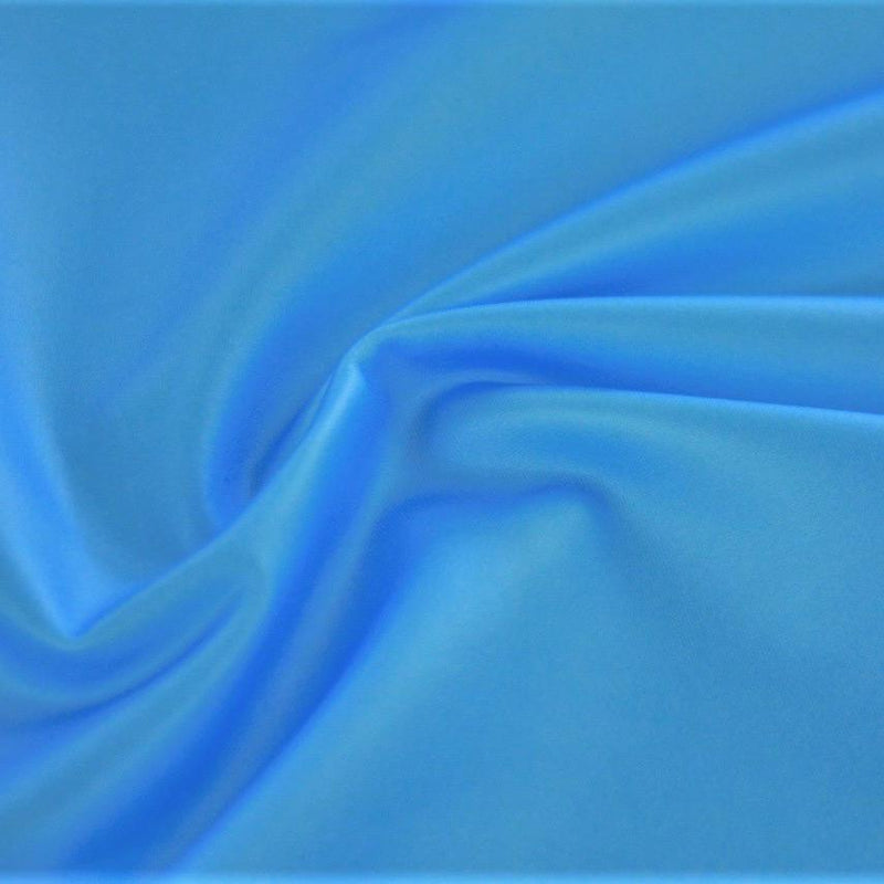 A swirled sample of luster soft foiled spandex in the color pool blue.
