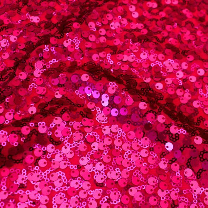 A swirled sample of marilyn stretch meh sequin in the color fuchsia.