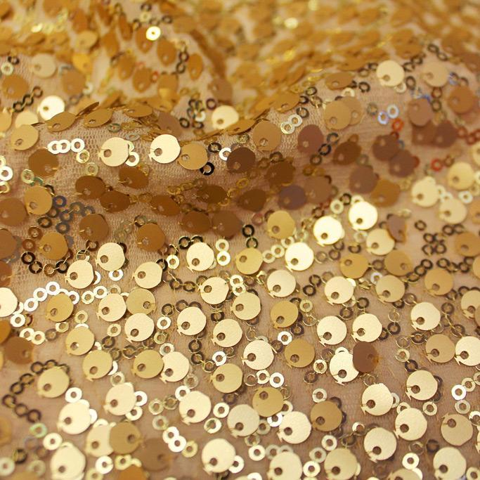A swirled sample of marilyn stretch meh sequin in the color gold.
