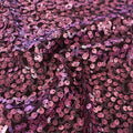 A swirled sample of marilyn stretch meh sequin in the color mauve.