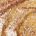 A swirled sample of marilyn stretch meh sequin in the color rose-gold.