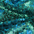 A swirled sample of marilyn stretch meh sequin in the color teal.