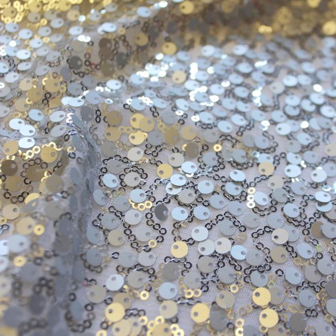 A swirled sample of marilyn stretch meh sequin in the color silver.