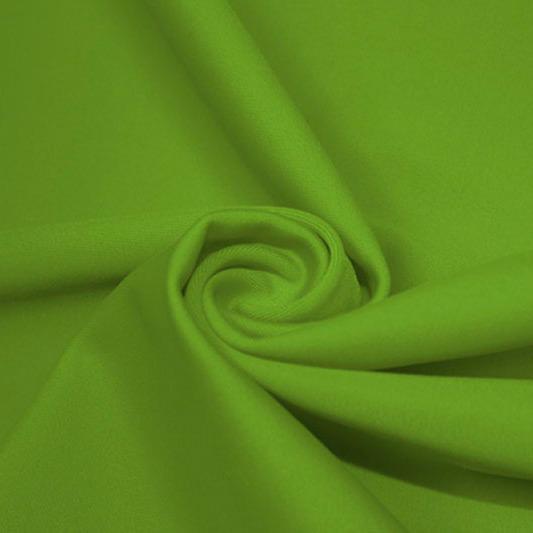 A swirled piece of matte nylon spandex fabric in the color apple green.