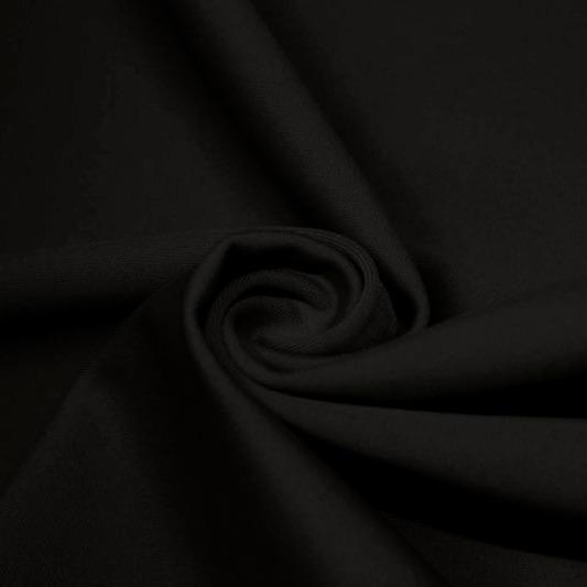 A swirled piece of matte nylon spandex fabric in the color black.