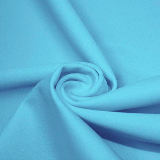 A swirled piece of matte nylon spandex fabric in the color blue lagoon.