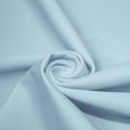 A swirled piece of matte nylon spandex fabric in the color blue star.