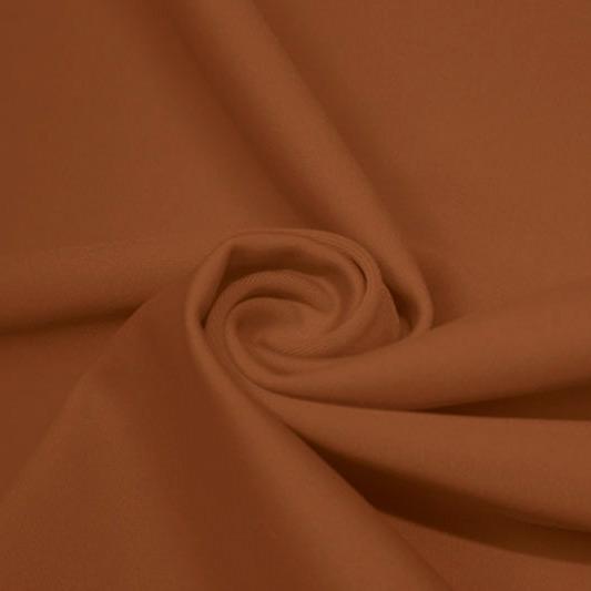 A swirled piece of matte nylon spandex fabric in the color bronze.