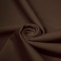 A swirled piece of matte nylon spandex fabric in the color brown sugar.