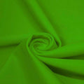 A swirled piece of matte nylon spandex fabric in the color caterpillar green.