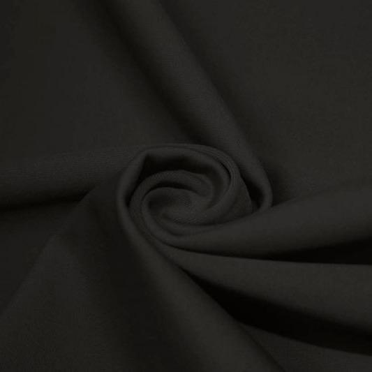 A swirled piece of matte nylon spandex fabric in the color charcoal.