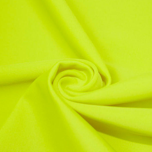 A swirled piece of matte nylon spandex fabric in the color chartreuse.