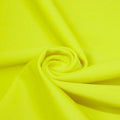 A swirled piece of matte nylon spandex fabric in the color citron.