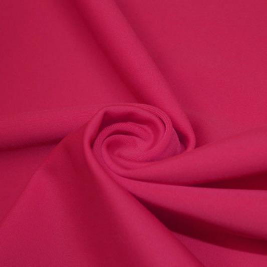 A swirled piece of matte nylon spandex fabric in the color dark magenta.