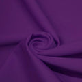 A swirled piece of matte nylon spandex fabric in the color dark purple.
