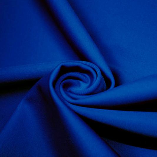 A swirled piece of matte nylon spandex fabric in the color deep royal.