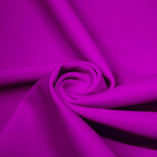 A swirled piece of matte nylon spandex fabric in the color electric purple.