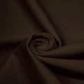 A swirled piece of matte nylon spandex fabric in the color espresso.
