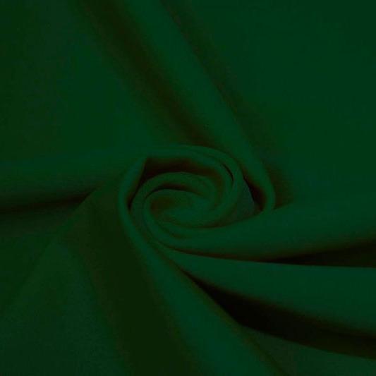 A swirled piece of matte nylon spandex fabric in the color evergreen.