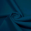 A swirled piece of matte nylon spandex fabric in the color fiji.