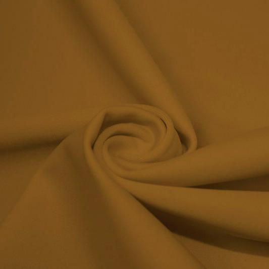 A swirled piece of matte nylon spandex fabric in the color golden.