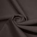 A swirled piece of matte nylon spandex fabric in the color graphite.