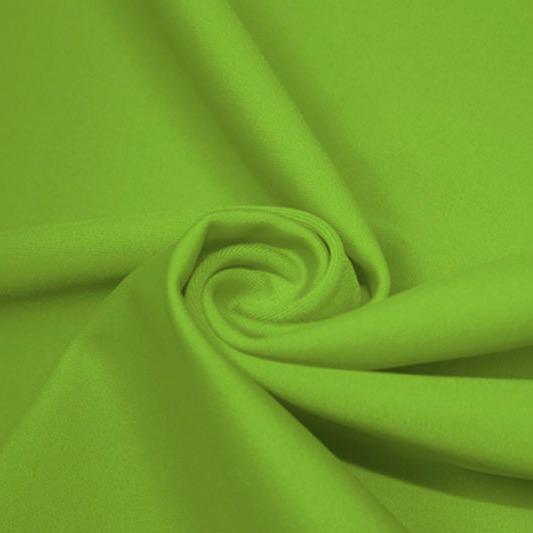 A swirled piece of matte nylon spandex fabric in the color grass.