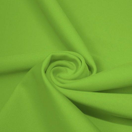 A swirled piece of matte nylon spandex fabric in the color grasshopper.