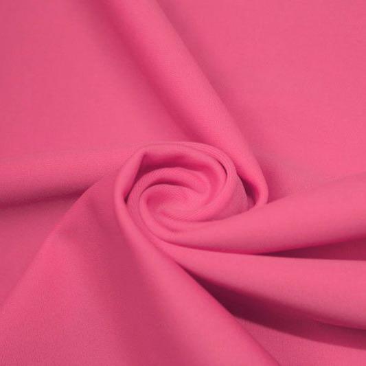 A swirled piece of matte nylon spandex fabric in the color guava.