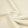 A swirled piece of matte nylon spandex fabric in the color ivory.