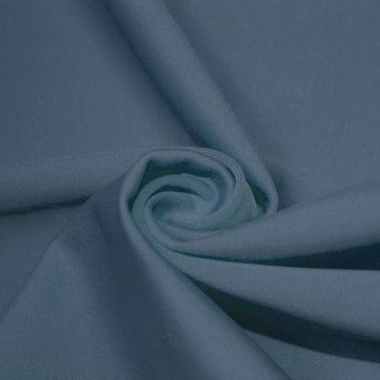 A swirled piece of matte nylon spandex fabric in the color jean.
