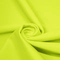 A swirled piece of matte nylon spandex fabric in the color lemon lime.