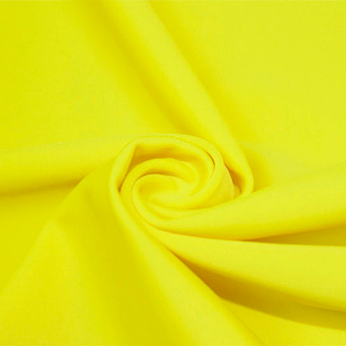 A swirled piece of matte nylon spandex fabric in the color lemonade.