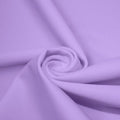 A swirled piece of matte nylon spandex fabric in the color lilac.