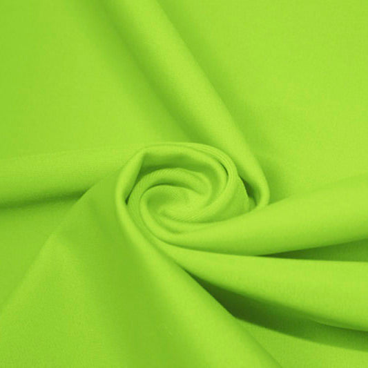 A swirled piece of matte nylon spandex fabric in the color lime.