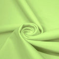A swirled piece of matte nylon spandex fabric in the color lucky charm.