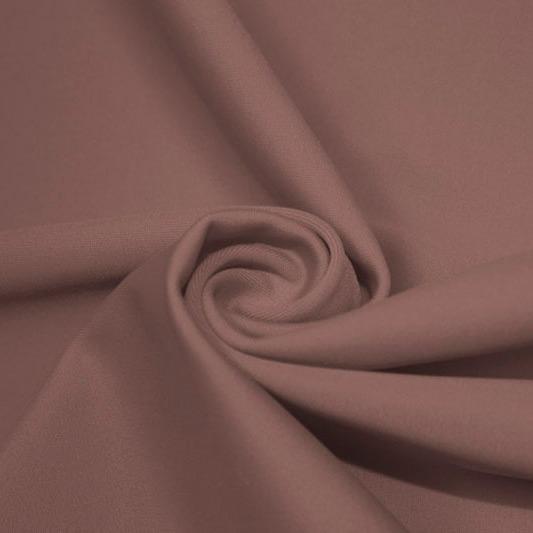 A swirled piece of matte nylon spandex fabric in the color mocha.