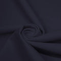 A swirled piece of matte nylon spandex fabric in the color navy blue.
