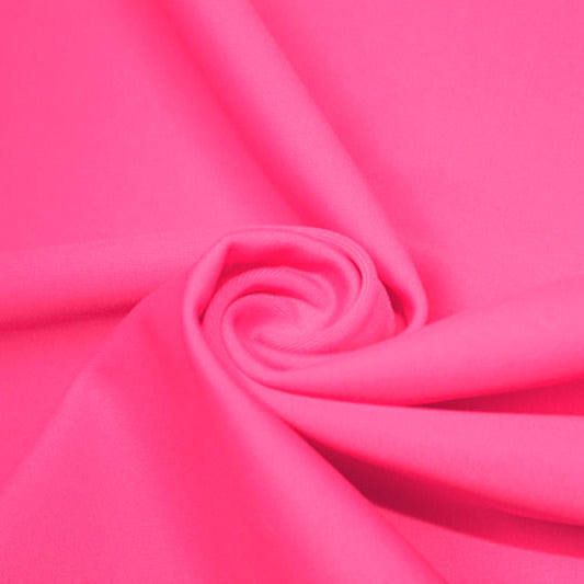 A swirled piece of matte nylon spandex fabric in the color neon pink.