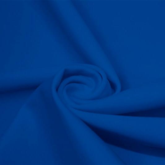 A swirled piece of matte nylon spandex fabric in the color new royal.