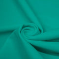 A swirled piece of matte nylon spandex fabric in the color ocean.