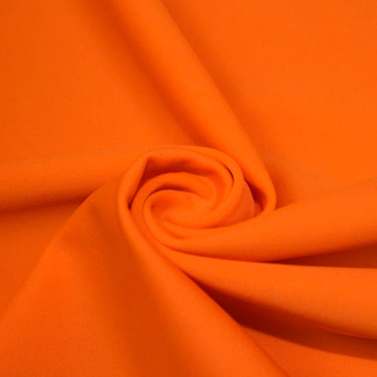 A swirled piece of matte nylon spandex fabric in the color outrageous orange.