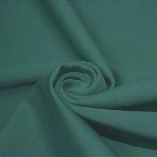 A swirled piece of matte nylon spandex fabric in the color pale cacti.