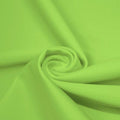 A swirled piece of matte nylon spandex fabric in the color pear.