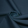 A swirled piece of matte nylon spandex fabric in the color pebble.