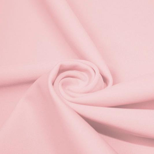 A swirled piece of matte nylon spandex fabric in the color pink.