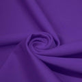 A swirled piece of matte nylon spandex fabric in the color purple.