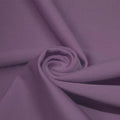 A swirled piece of matte nylon spandex fabric in the color purple haze.