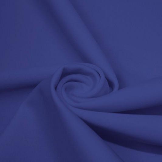 A swirled piece of matte nylon spandex fabric in the color real royal blue.